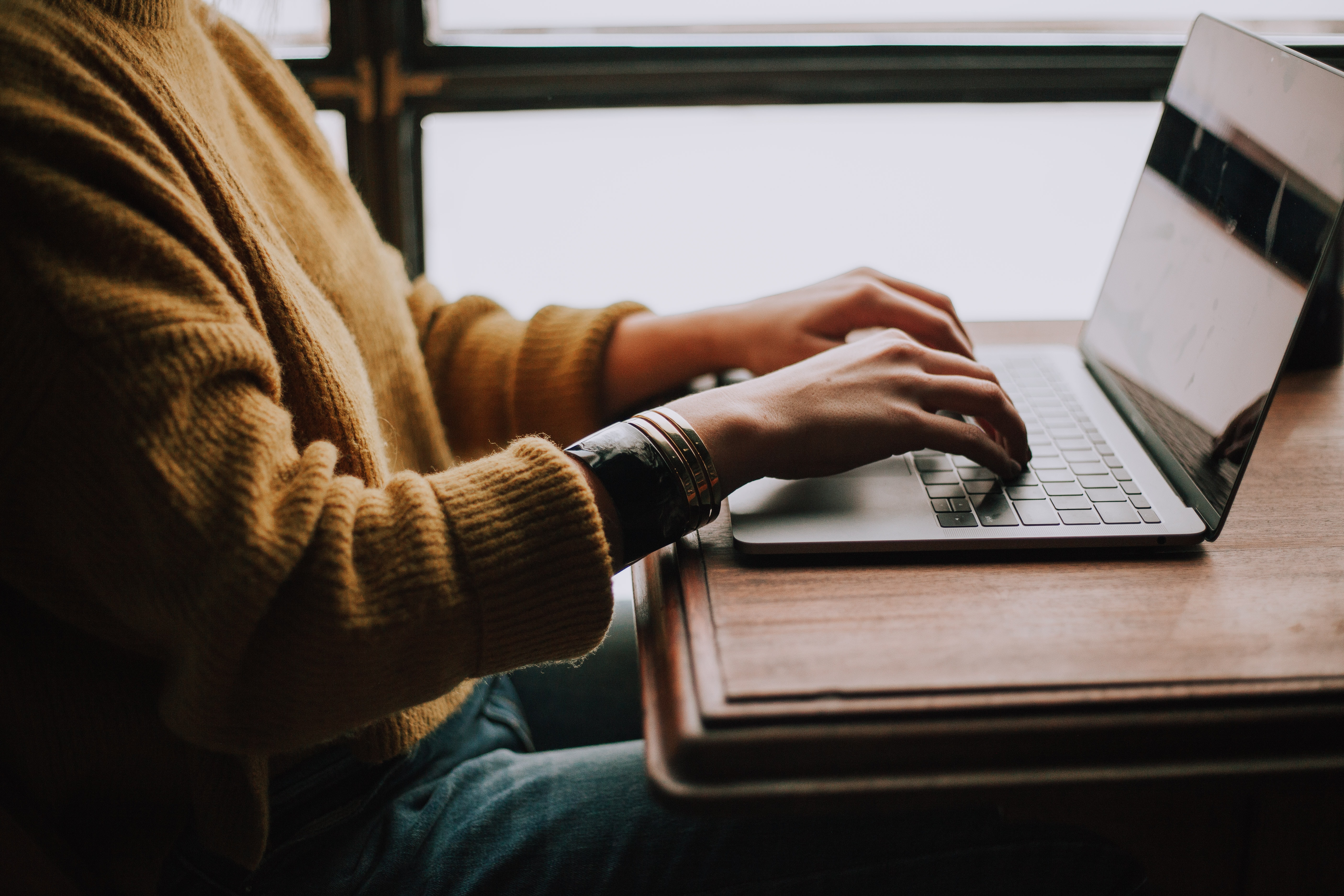 Woman writing on her computer